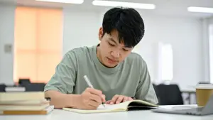 Student revising GCSE English with notes and textbooks before the exams.