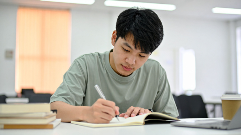 Student revising GCSE English with notes and textbooks before the exams.