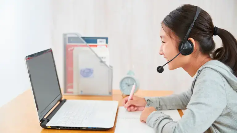 Student receiving online GCSE English tuition to improve exam skills.