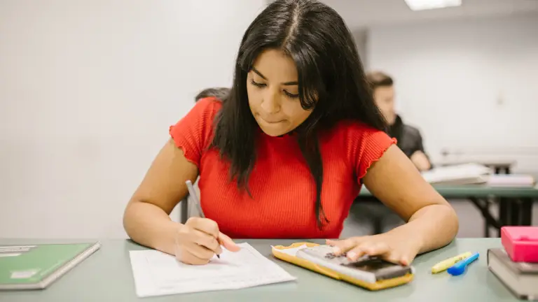 Student checking GCSE English exam answers before finishing.