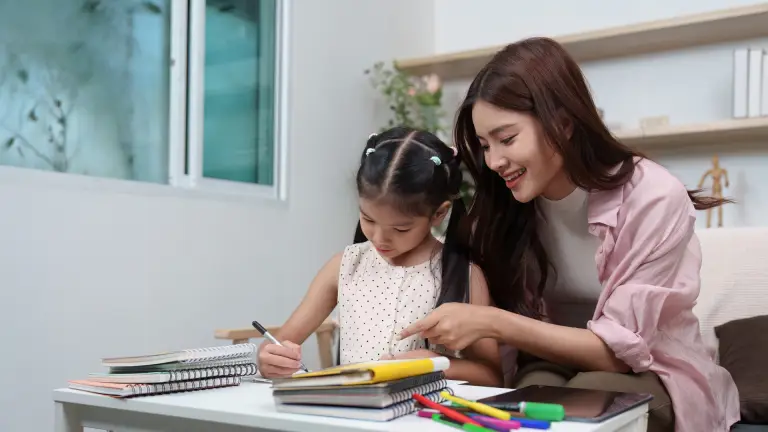 Parent encouraging their child while completing schoolwork at home.