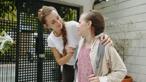 Parent talking with their child before returning to school to help build confidence.
