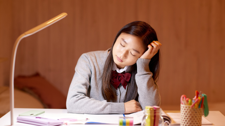 Student thinking carefully while working on schoolwork at home.