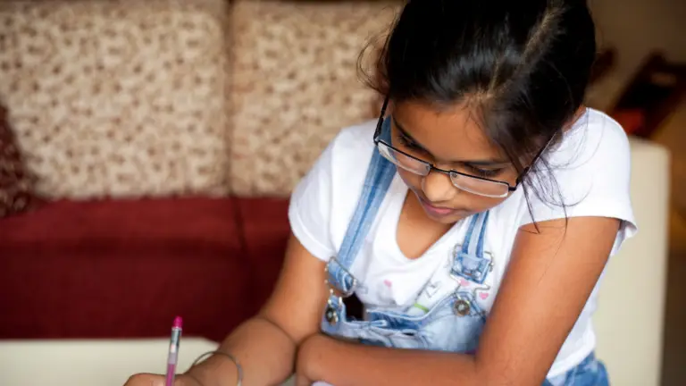 Student completing homework at home after returning to school.
