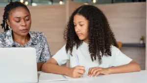 Parent discussing schoolwork with their child at home.