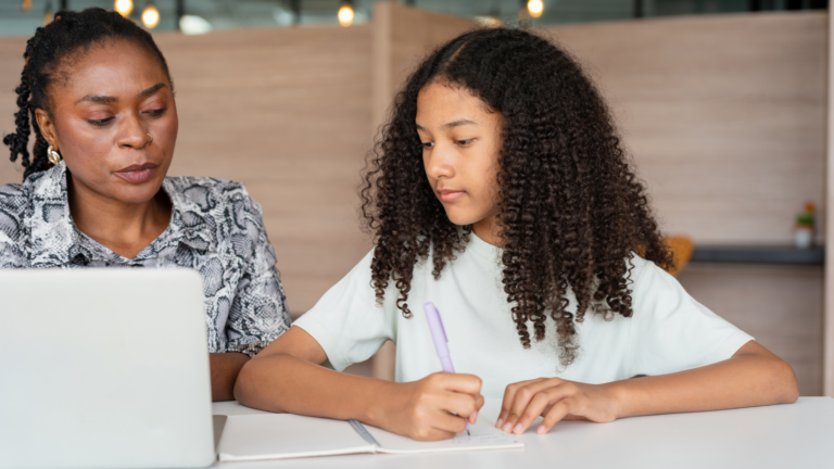 Parent discussing schoolwork with their child at home.
