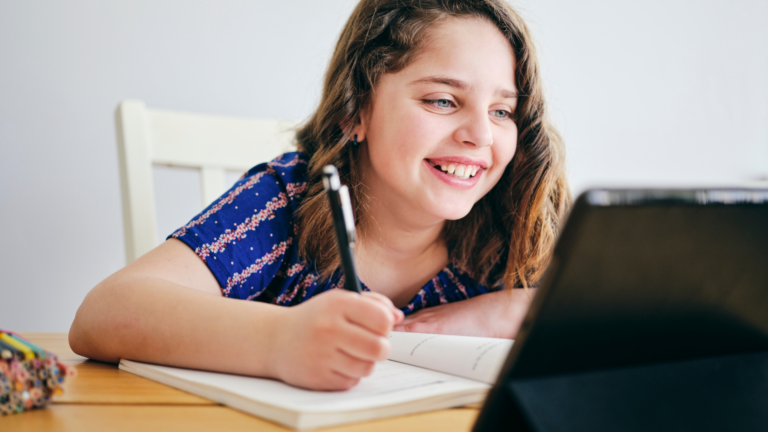 Student receiving one-to-one online tuition using a laptop.