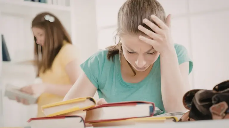 Student finding a piece of homework challenging while studying at home.
